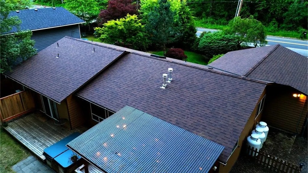 Newly installed asphalt shingle roof on a large modern house in Edmonds, WA